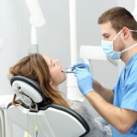 periodontist checking patient mouth